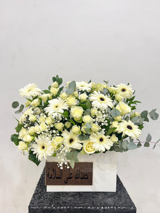 White and green funeral flowers kw