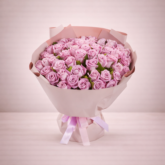 Bouquet of pink roses wrapped in white paper with a pink ribbon on a light pink background