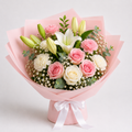A beautifully arranged floral bouquet wrapped in light pink paper with a white ribbon bow at the base. The bouquet features pink and white roses, white lilies, pink carnations, white carnations, baby's breath, and green eucalyptus leaves.
