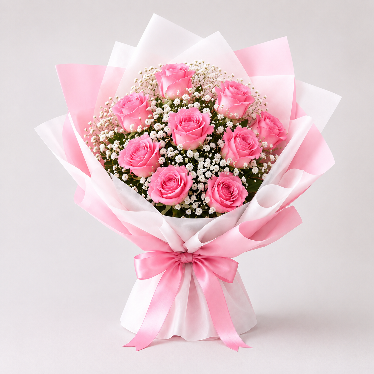 Pink rose bouquet with baby's breath wrapped in pink and white tissue with satin ribbon bow – flower delivery Kuwait.